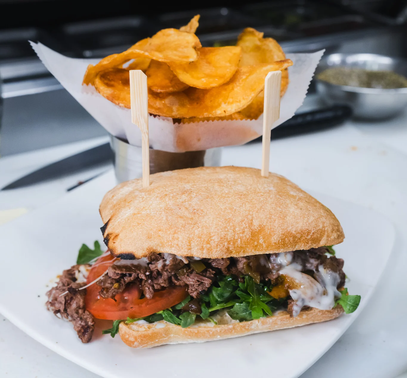 Steak sandwich at Wild Carvery in Burbank with sliced steak, melted cheese, peppers, tomato and arugula