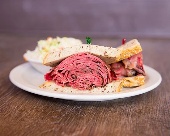 Classic pastrami sandwich on rye bread with coleslaw