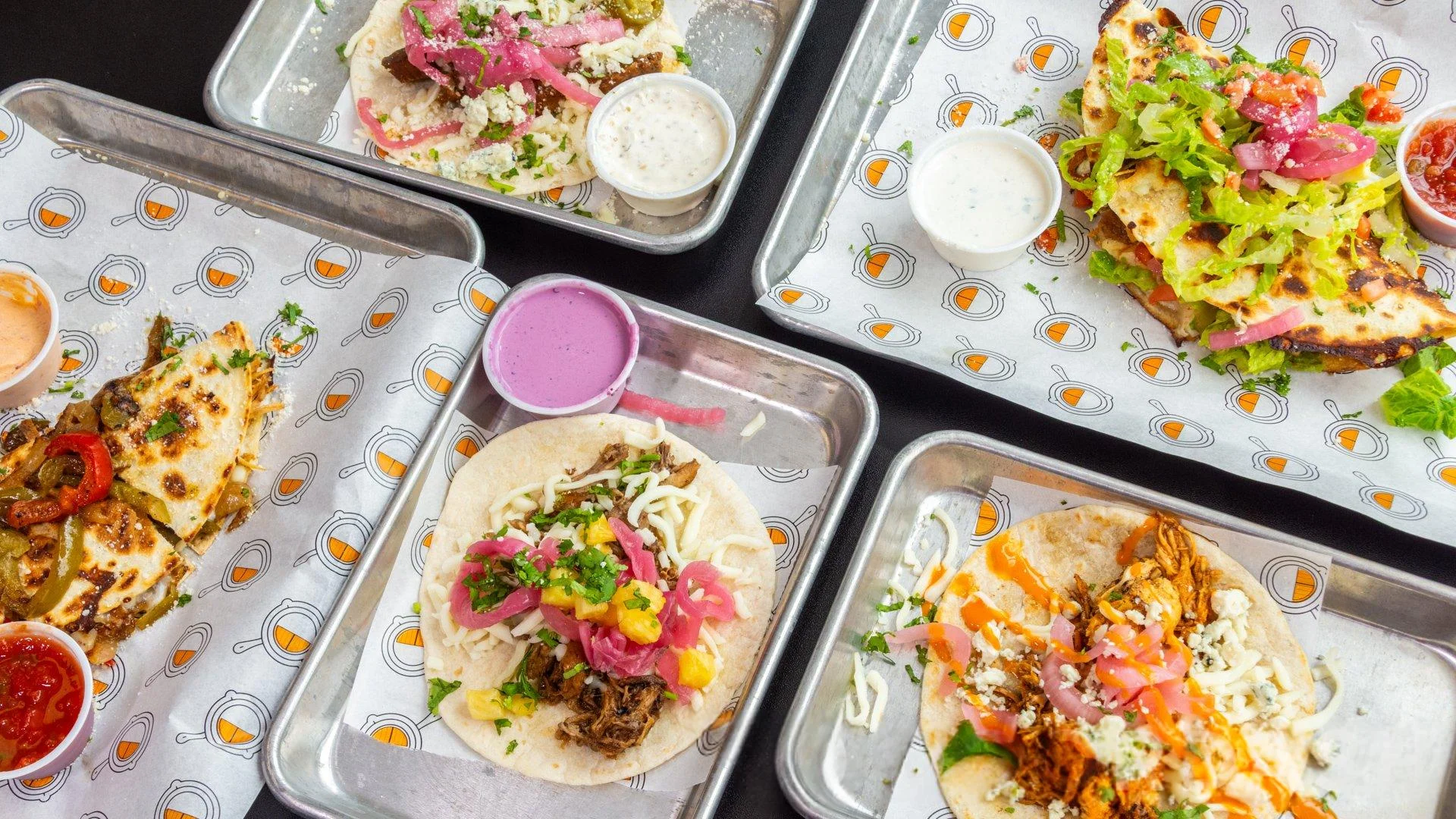 Assorted Mexican tacos with vibrant toppings and sauces