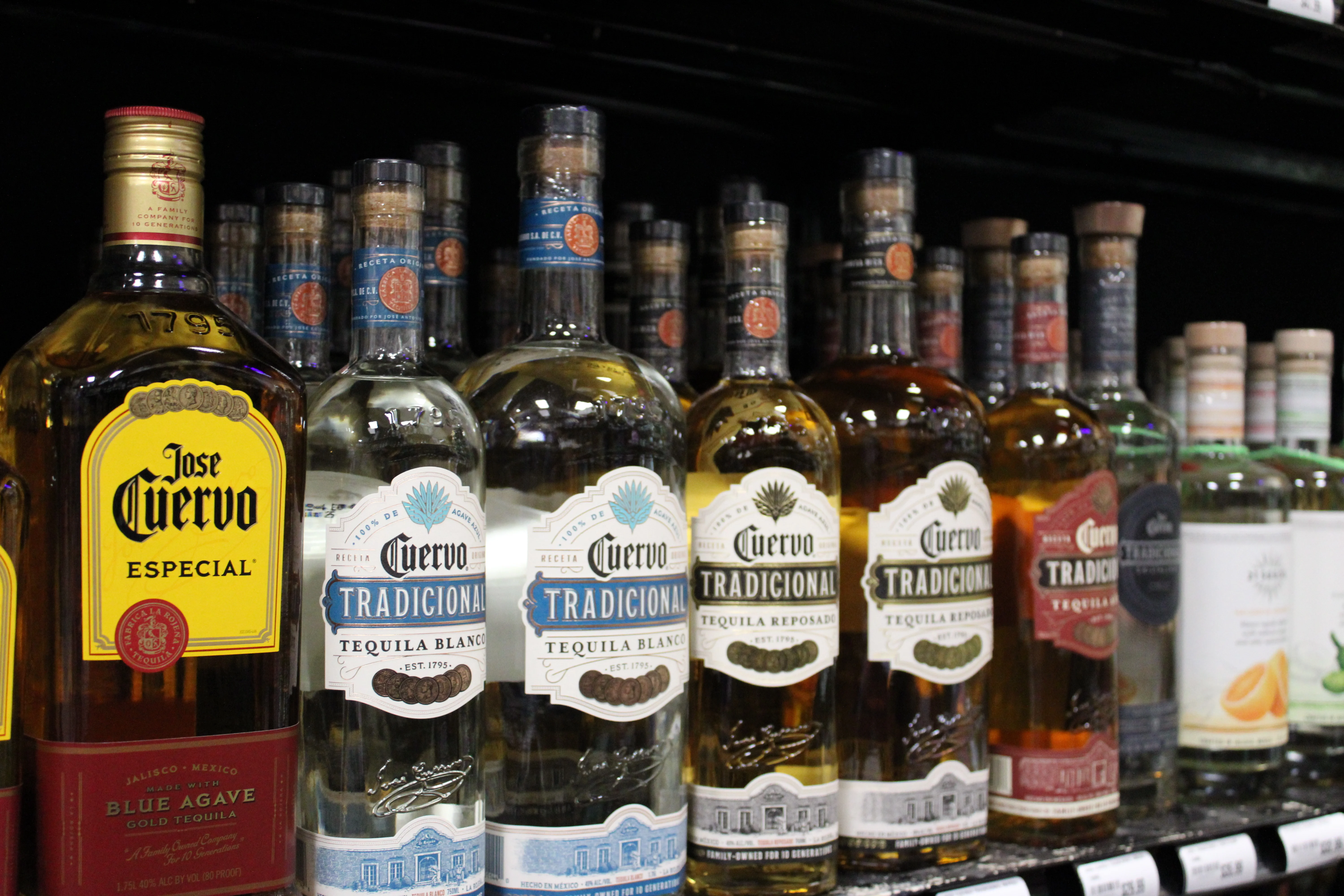 Selection of premium tequila bottles on a store shelf