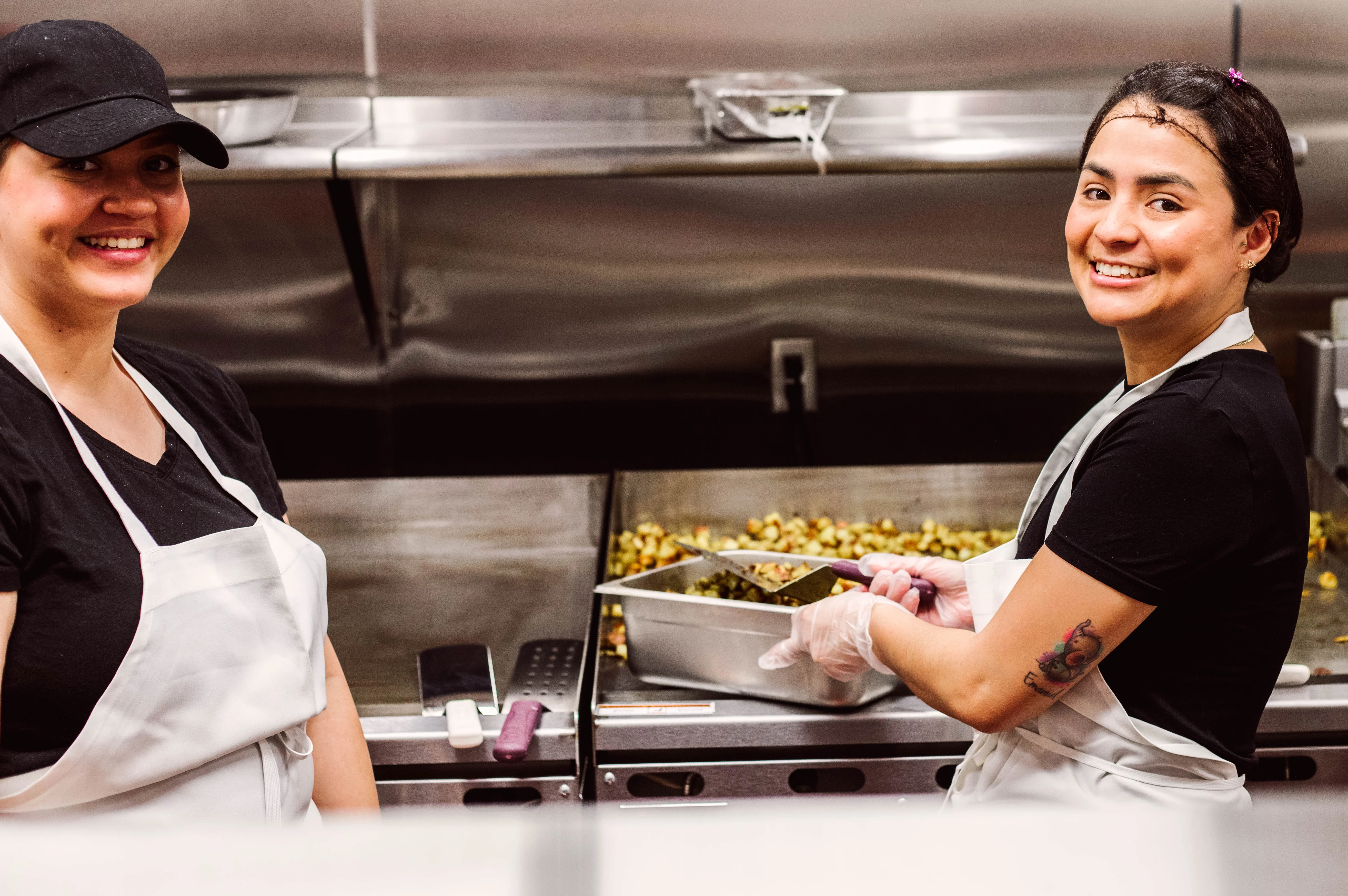 Chefs preparing fresh ingredients in a bustling restaurant kitchen