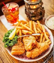 Crispy fish and chips served with fries and lemon