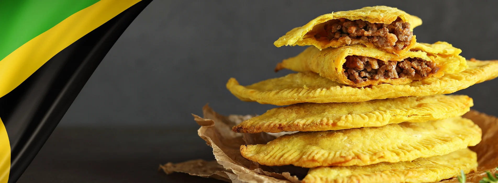 Jamaican beef patty stacked on parchment paper