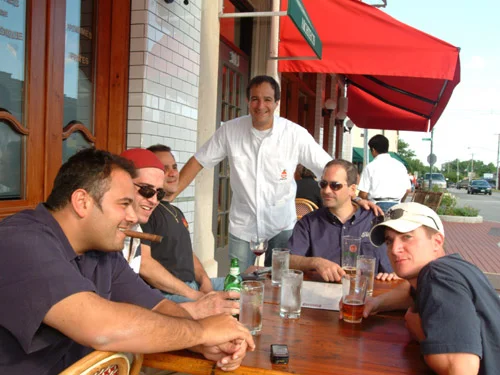Group of friends enjoying drinks at a restaurant patio