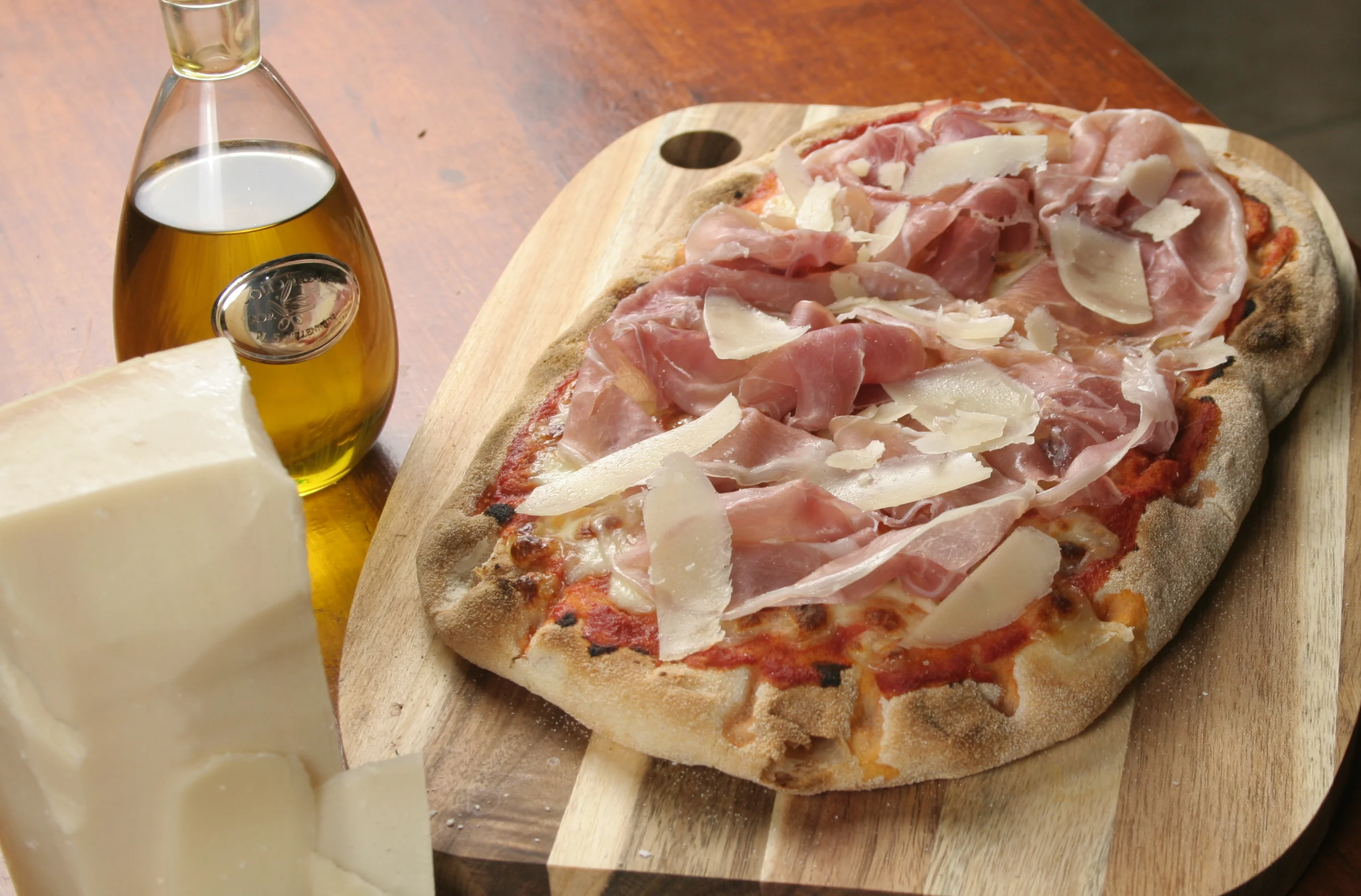 Parma Roman pinsa topped with prosciutto di parma and shaved Parmigiano cheese at Daje Pinsa Roman Pizza in Orlando.