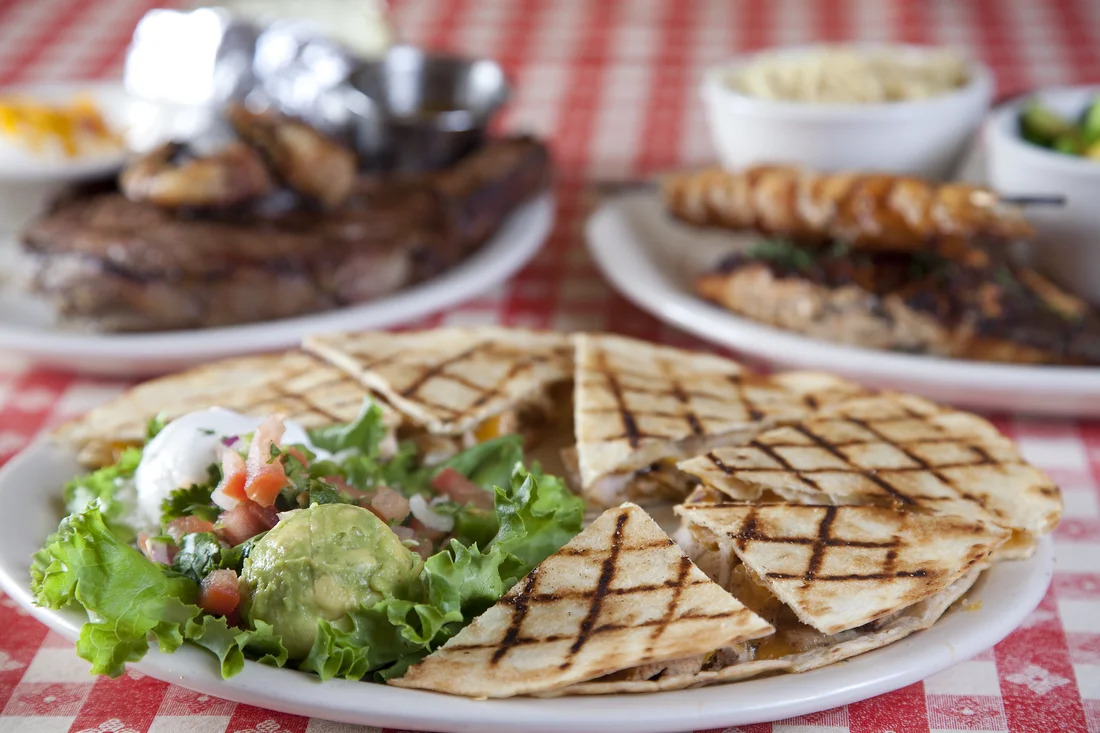 Grilled chicken quesadilla with fresh salad and guacamole