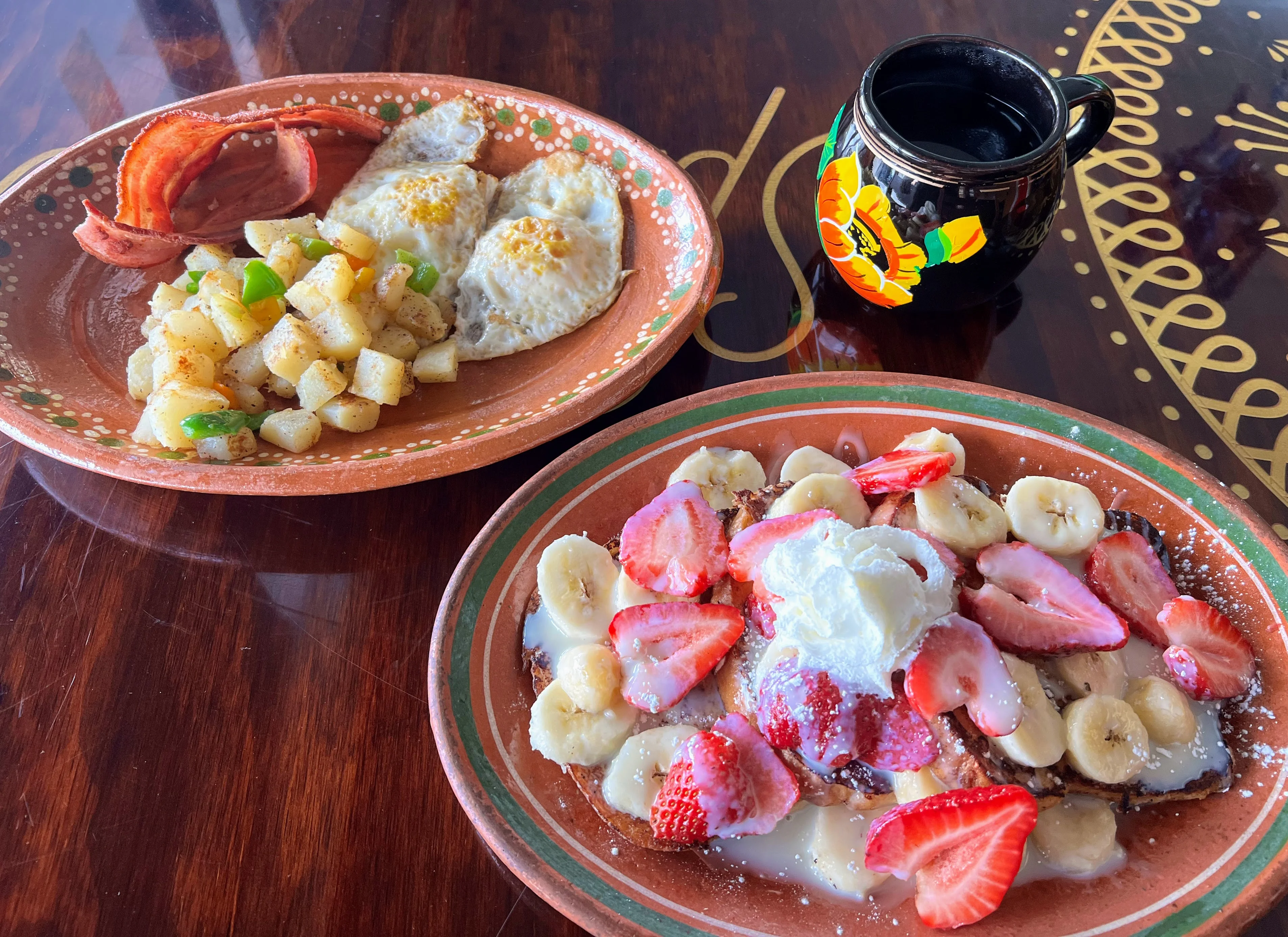 Delicious Mexican breakfast with eggs, bacon, and French toast topped with fruit