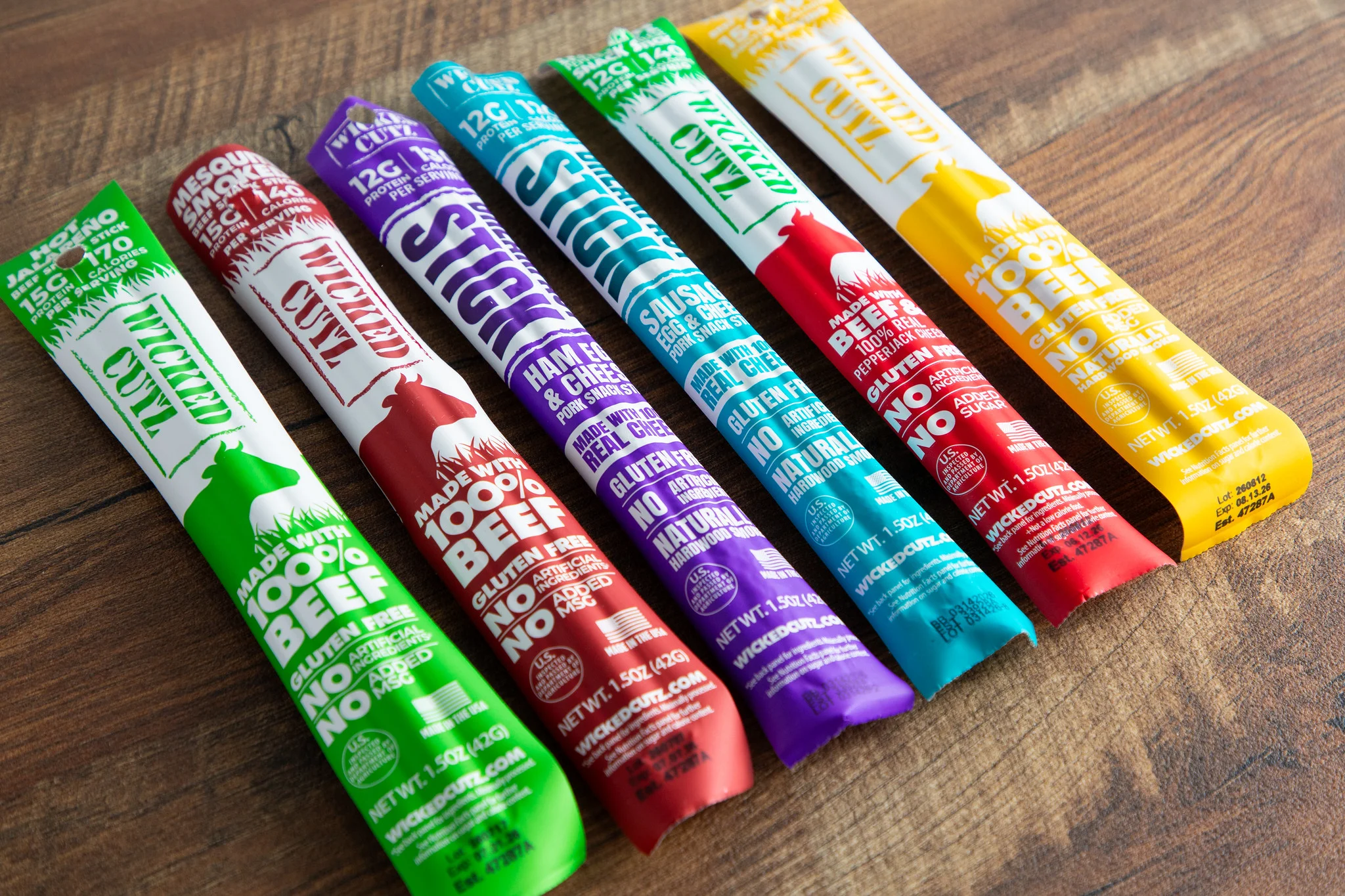Variety of beef jerky sticks in colorful packaging