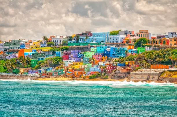 Colorful coastal houses on a hillside by the ocean