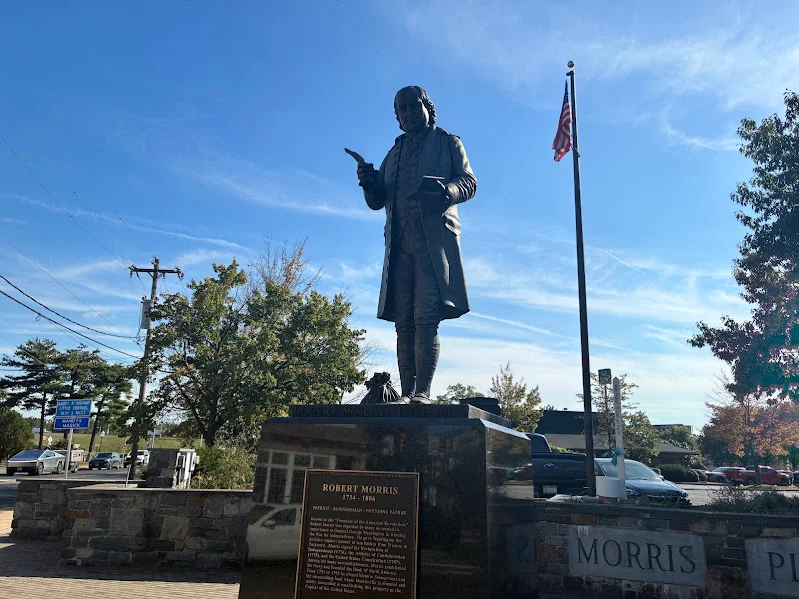 Statue of Robert Morris with American flag in background