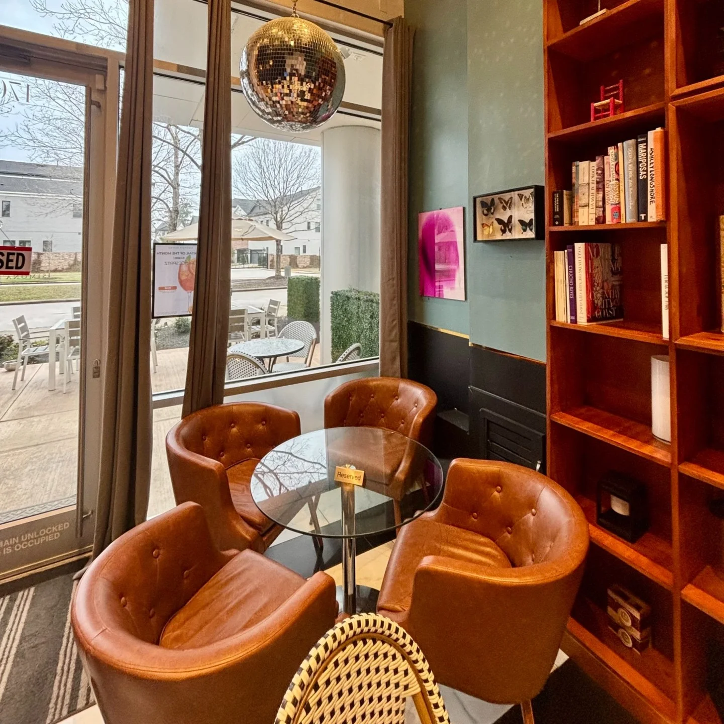 Cozy restaurant interior with leather chairs and a disco ball