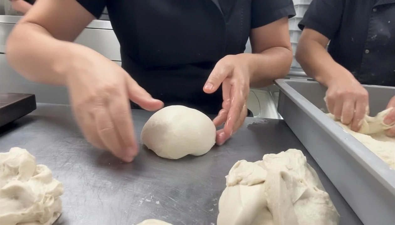 Chef kneading dough for artisan bread preparation