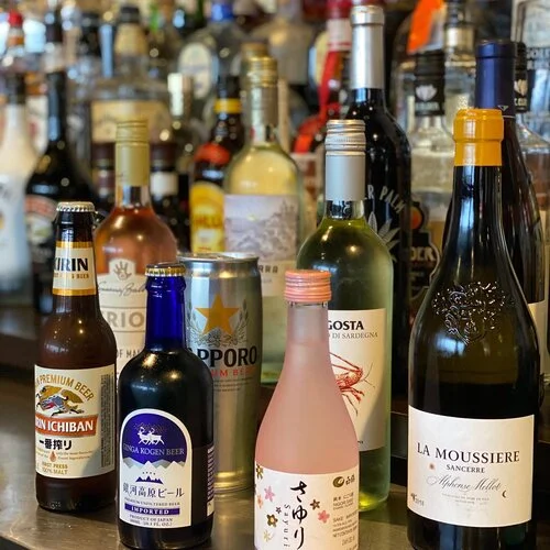 Variety of international beverages on a bar shelf