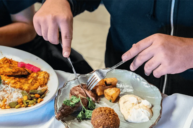 Customers seated and enjoying their meals inside Malek Al Kabob