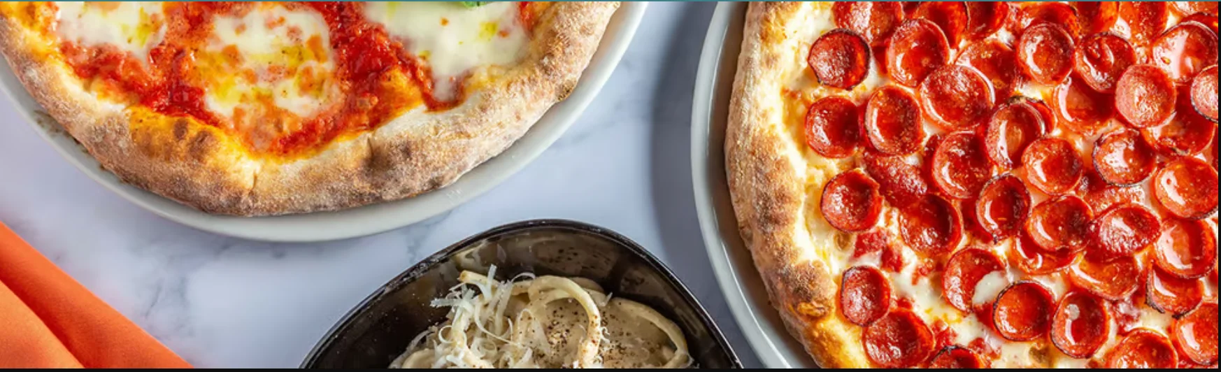Pepperoni pizza and classic Margherita pizza on a marble table