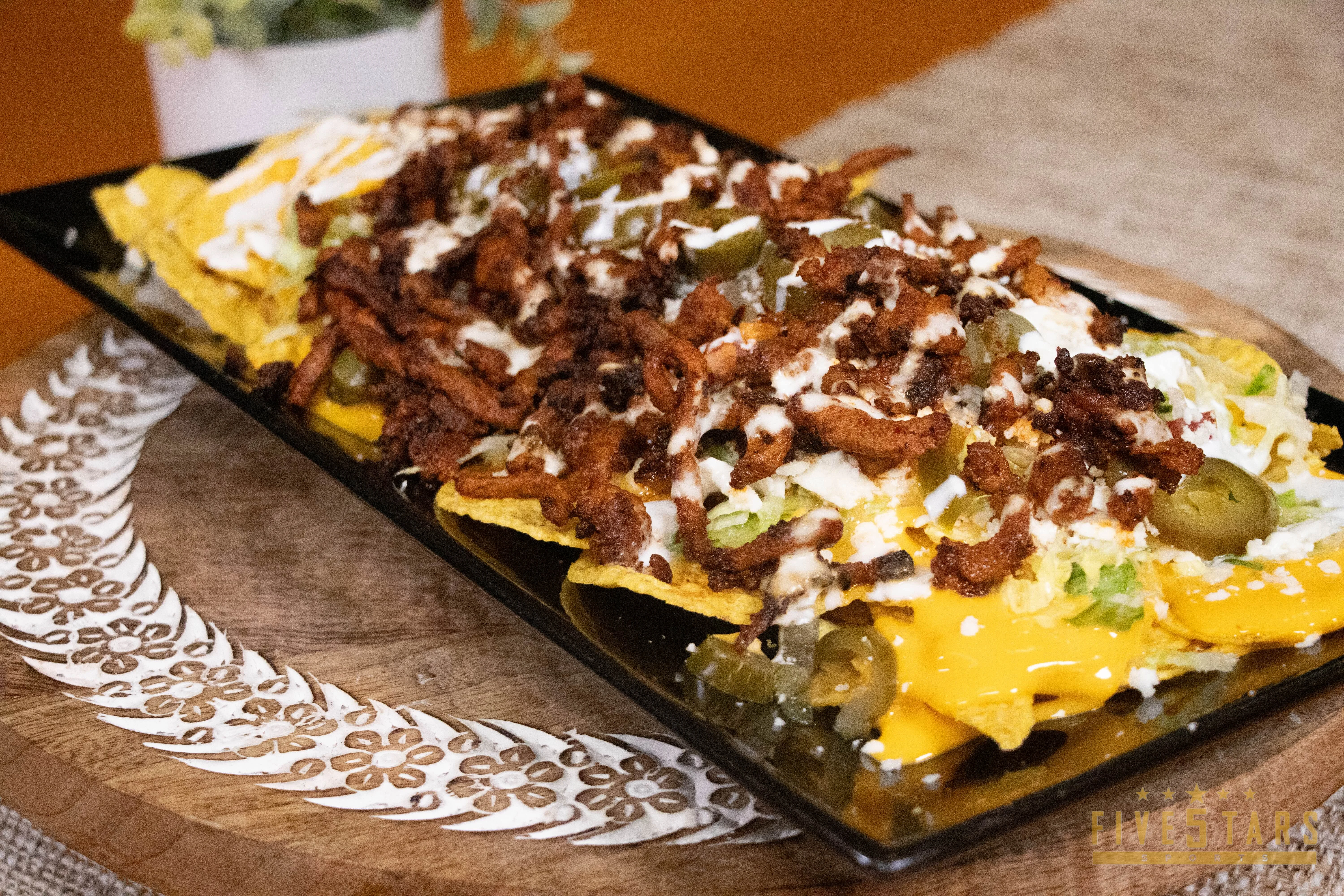 Loaded nachos with toppings in a vibrant presentation
