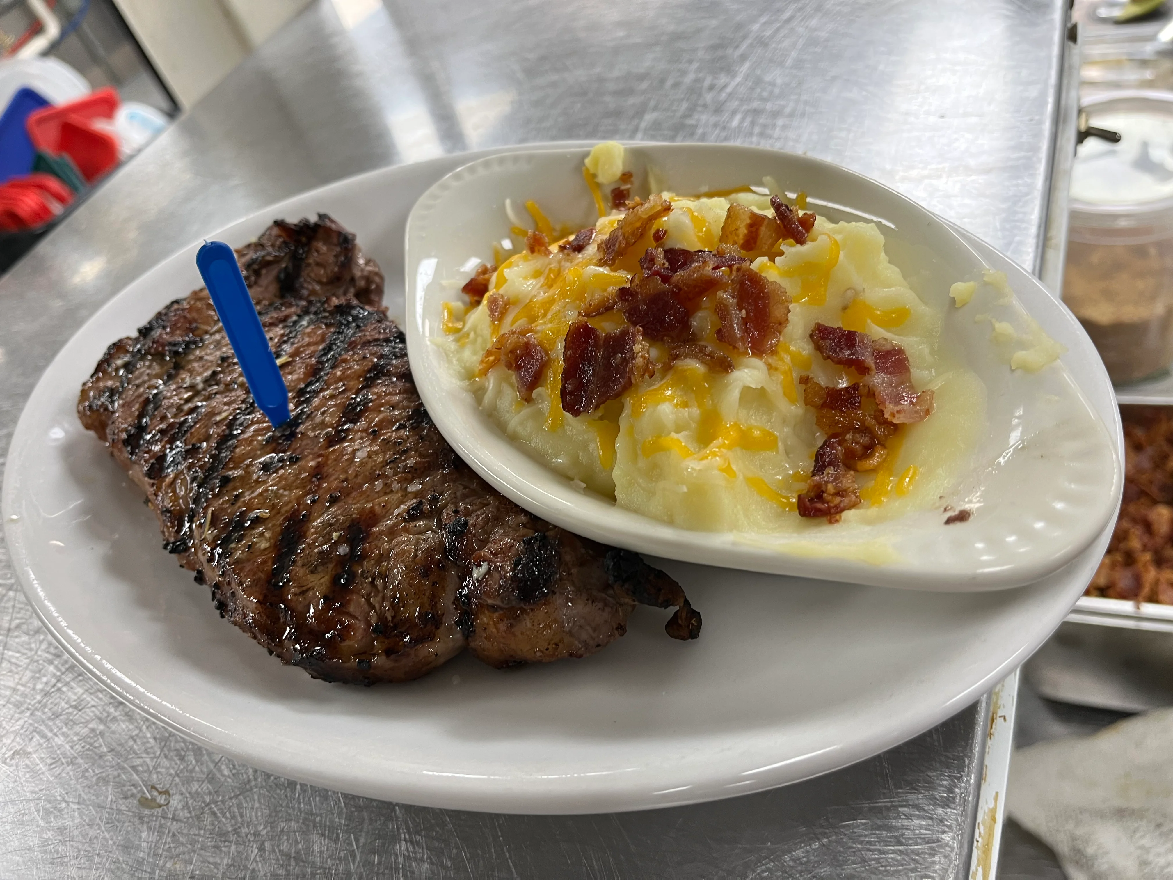 Grilled steak with loaded mashed potatoes