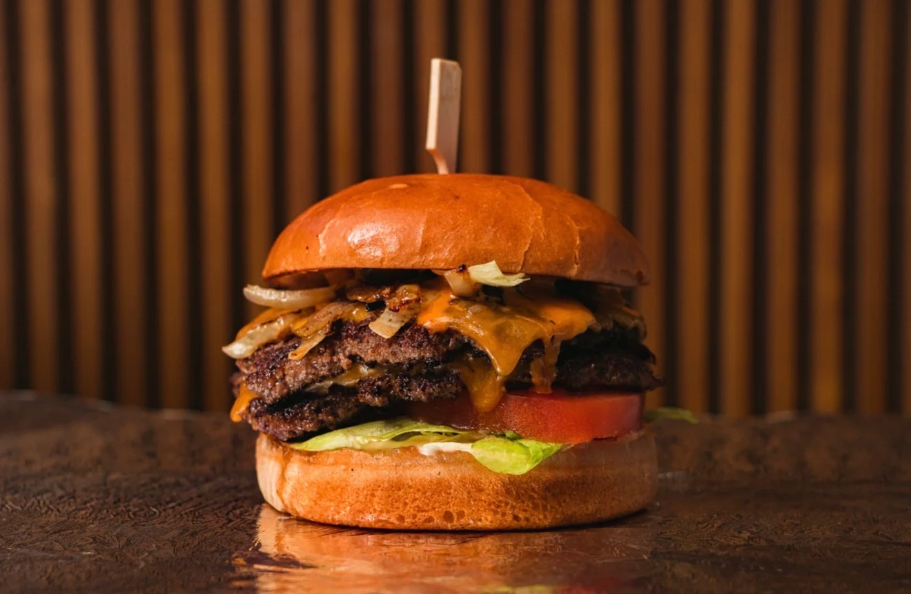 Juicy cheeseburger with grilled onions and fresh toppings