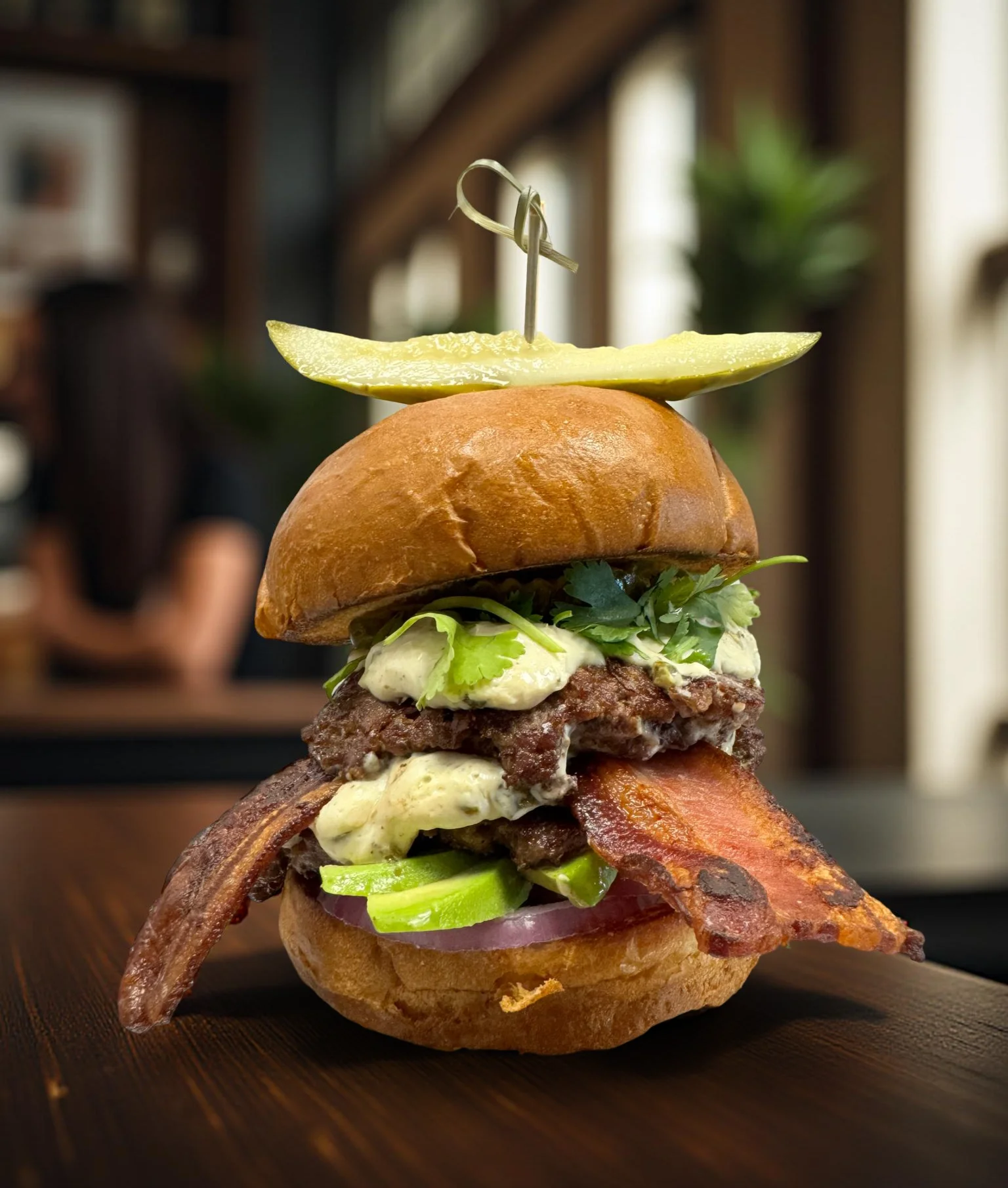 Delicious gourmet burger with fresh toppings on a wooden table