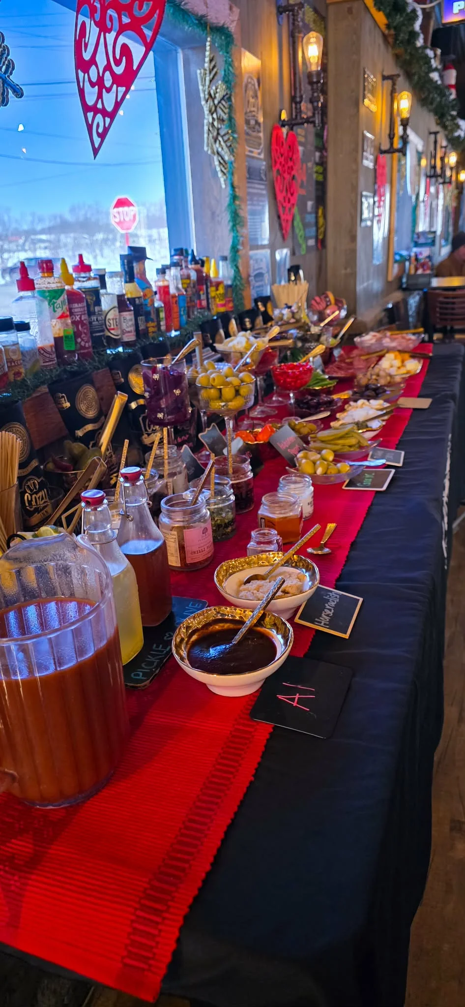 Colorful cocktail garnish bar with various toppings and mixers