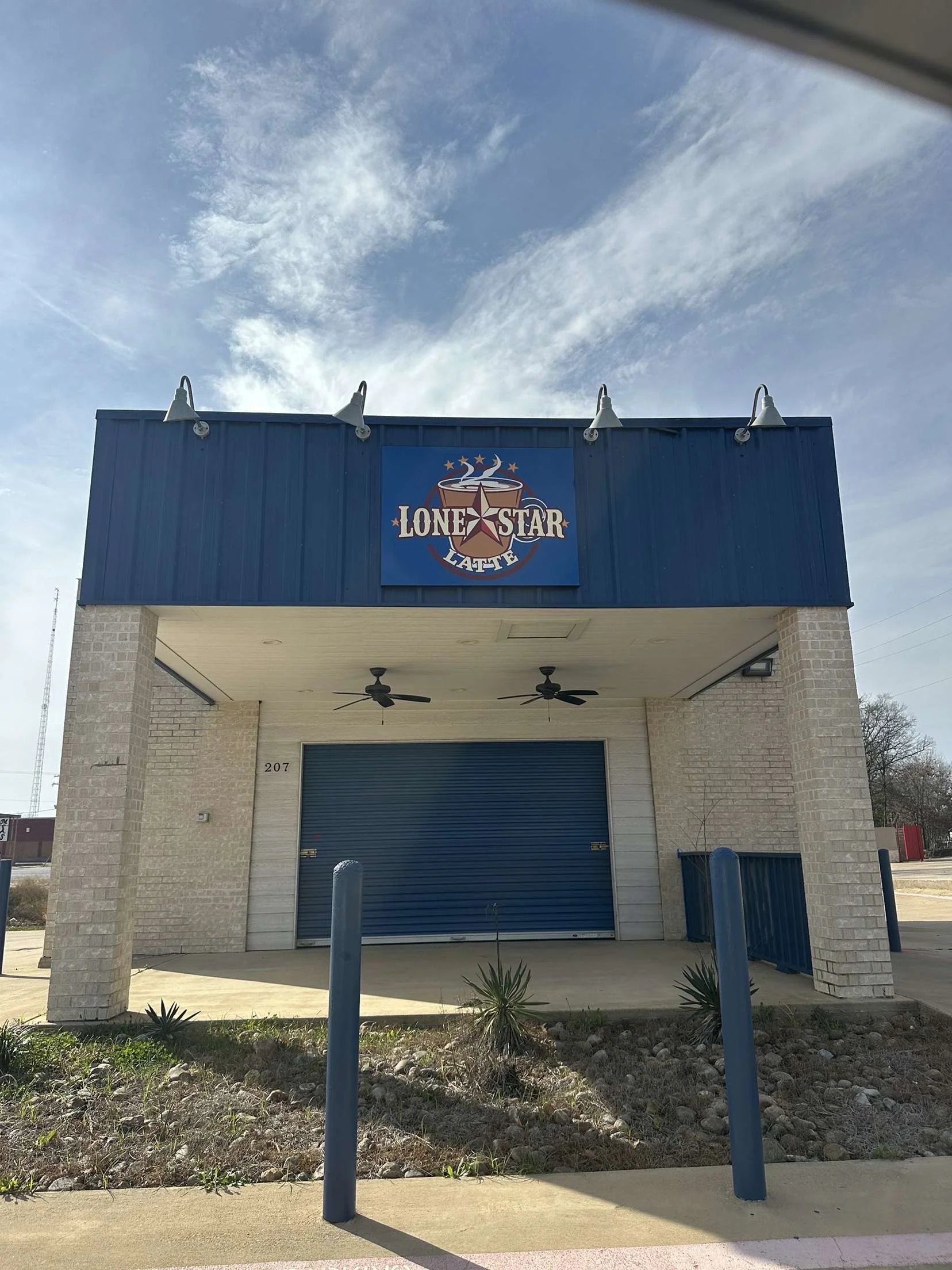 Exterior view of Lone Star Latte coffee shop with blue awning