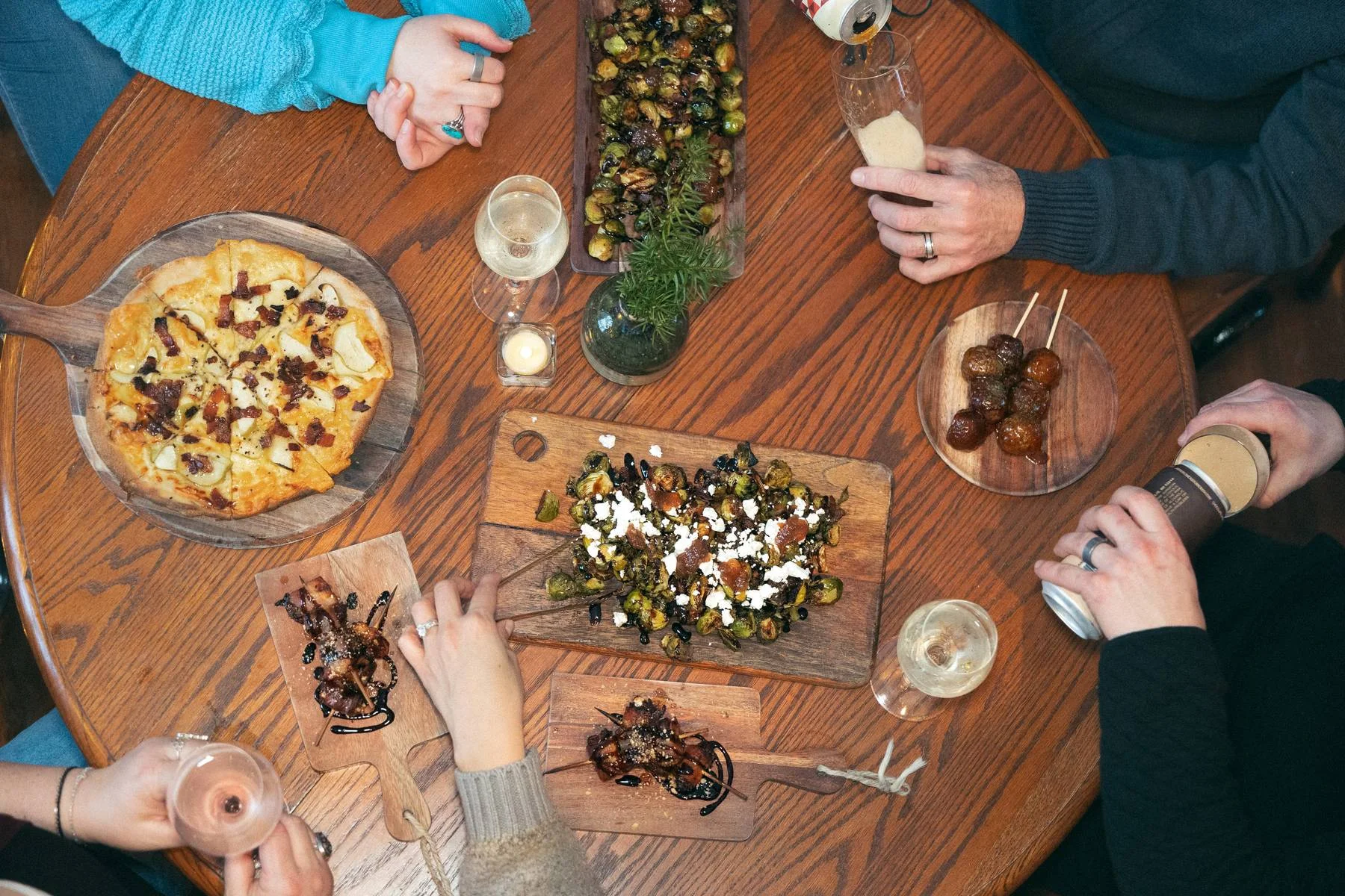 Gourmet flatbread pizza with toppings on a rustic wooden table