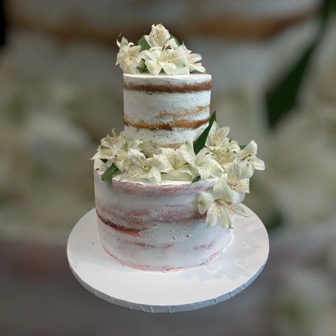 Elegant two-tiered wedding cake adorned with fresh flowers