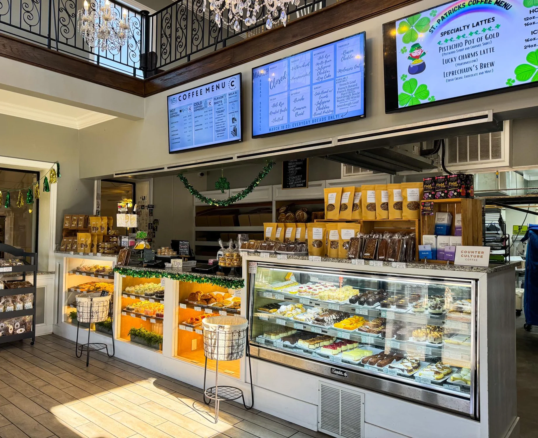 Charming café interior with pastries and coffee menu displays