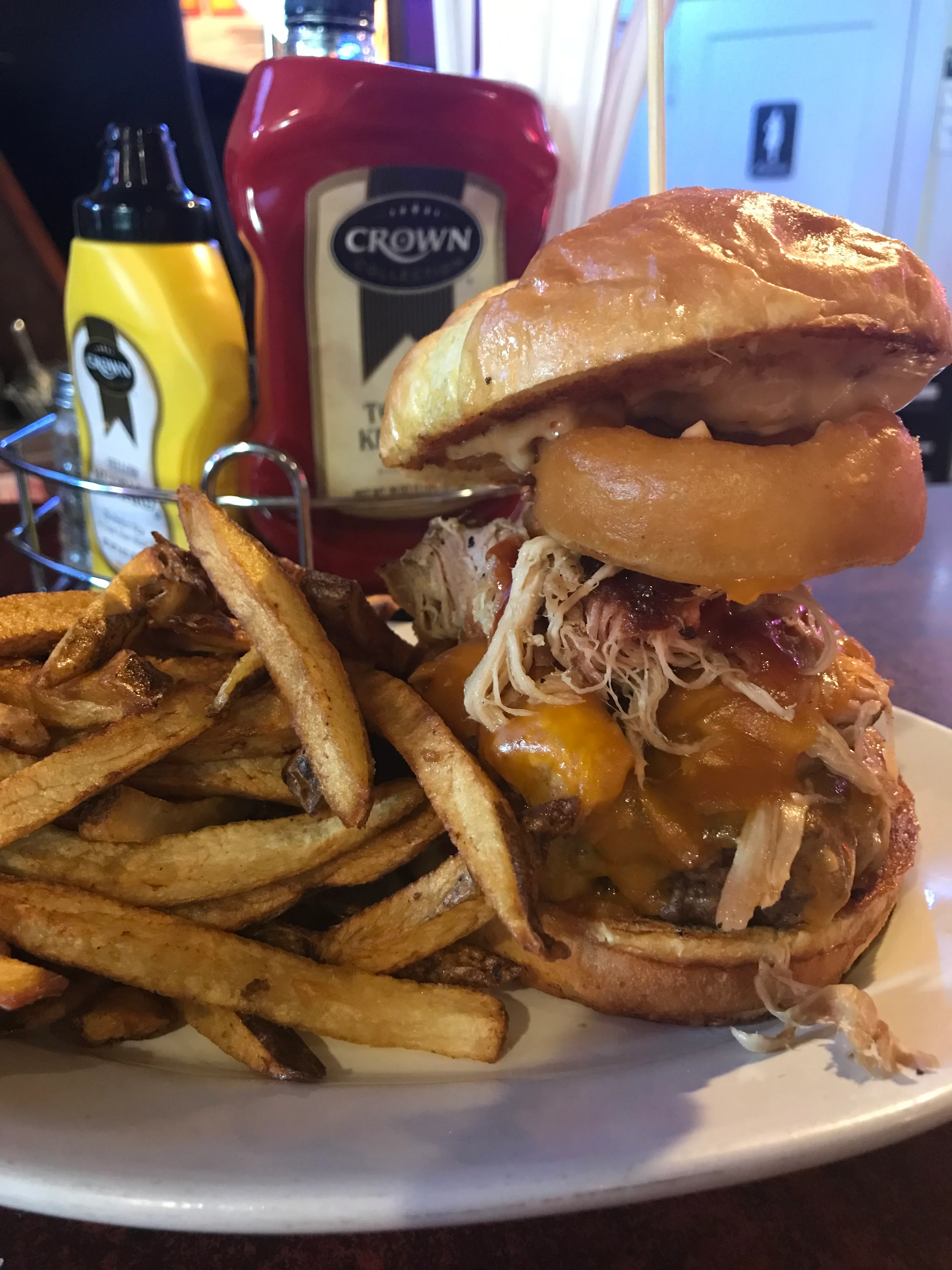 BBQ pulled pork burger with fries and condiments