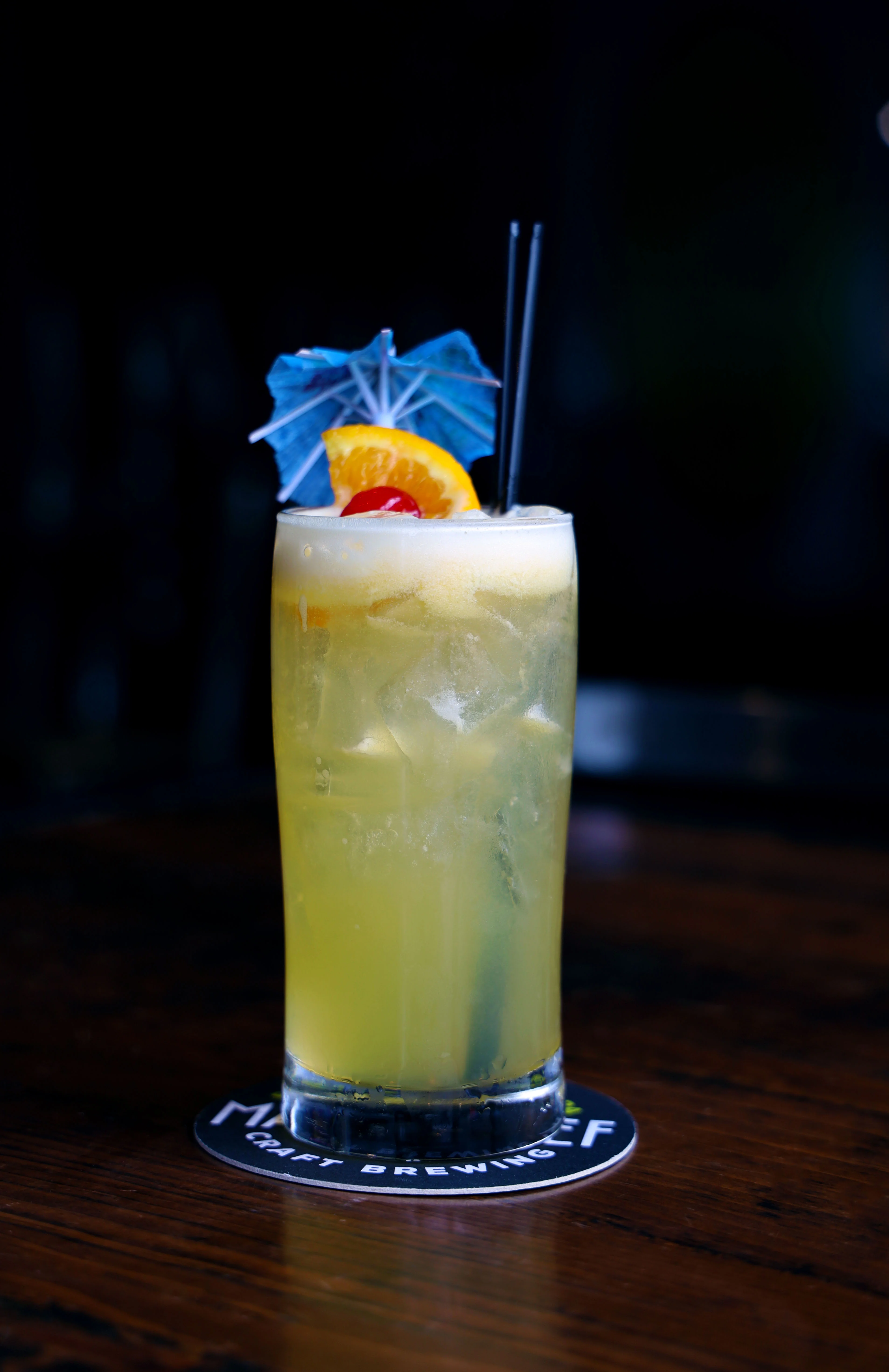 Tropical cocktail garnished with fruit and an umbrella