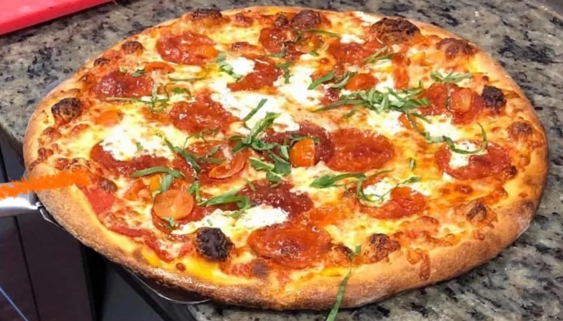 Pepperoni pizza with fresh basil and mozzarella