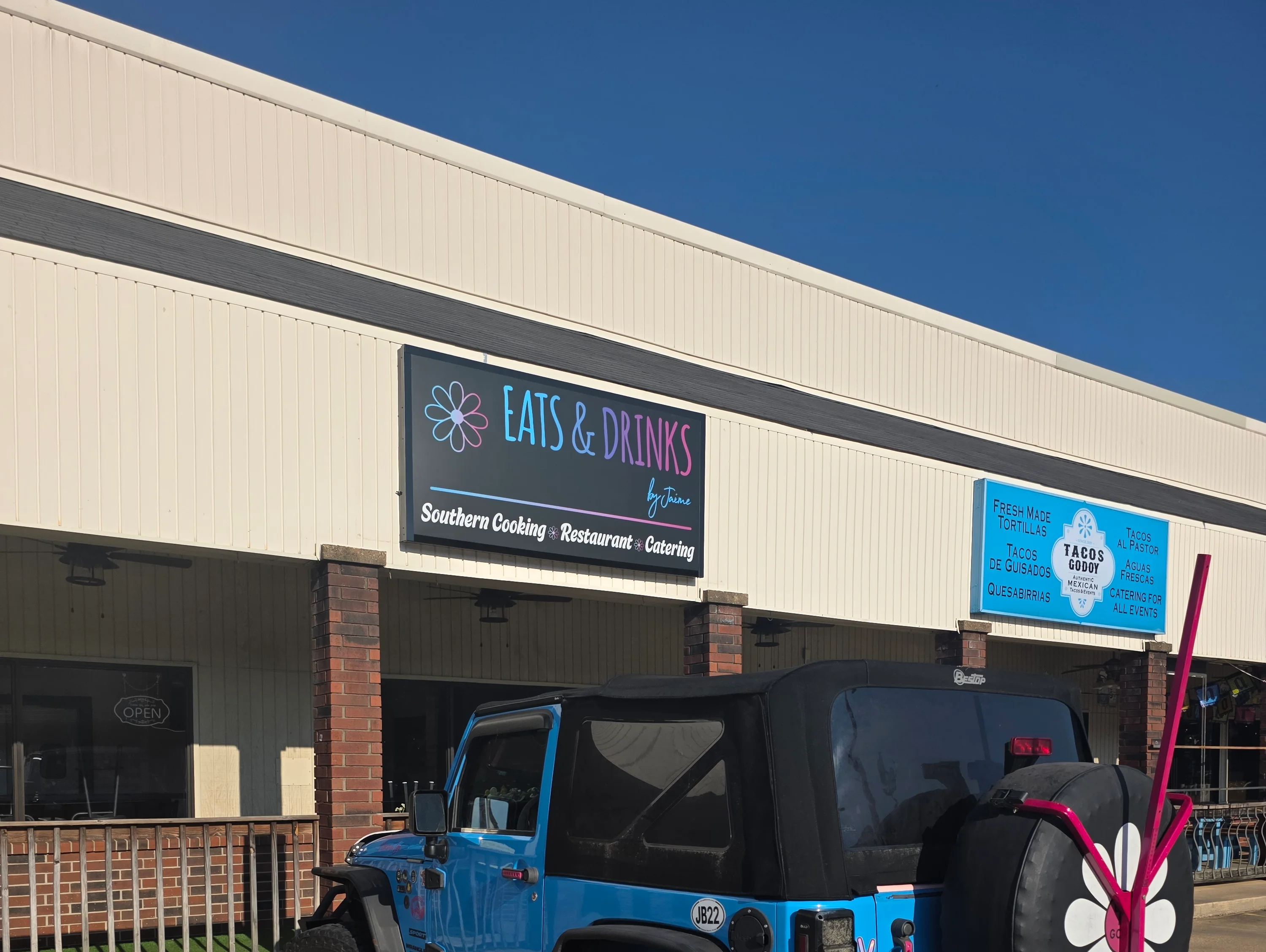 Exterior view of Eats & Drinks restaurant with vibrant signage