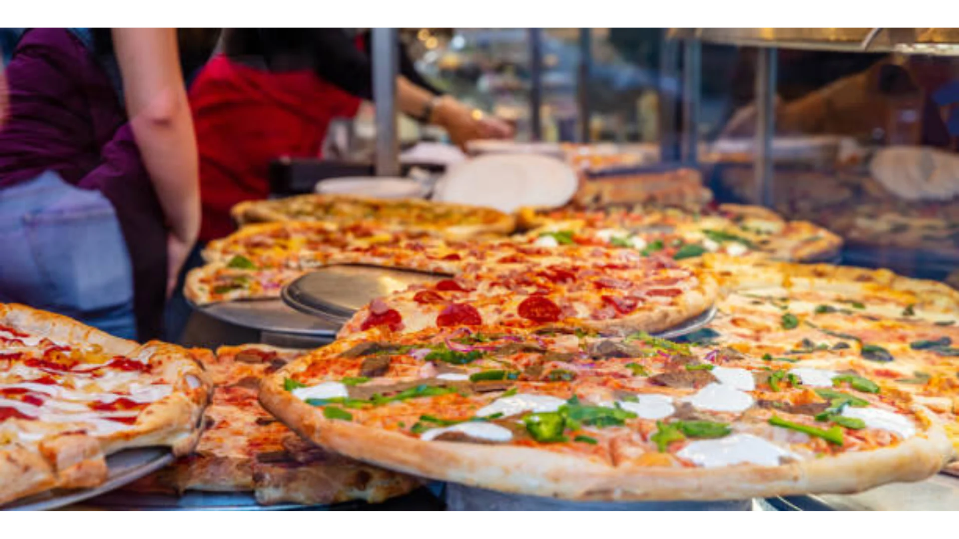 Variety of pizzas displayed at a food market