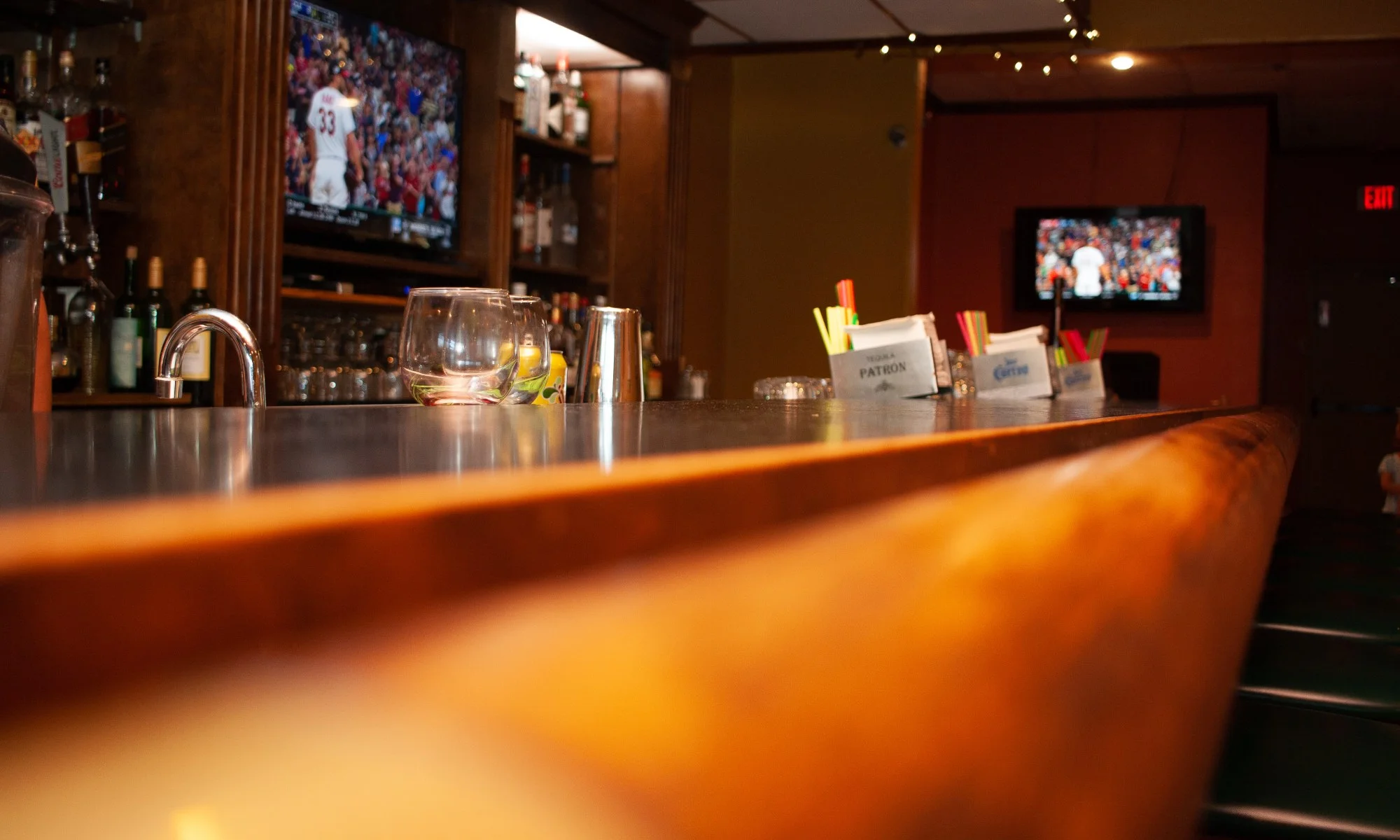 Cozy bar interior with cocktails and TVs