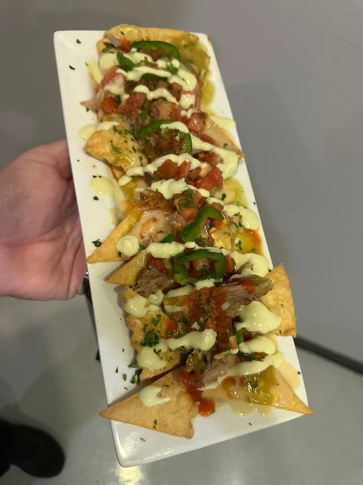 Loaded nachos topped with meat and sauces