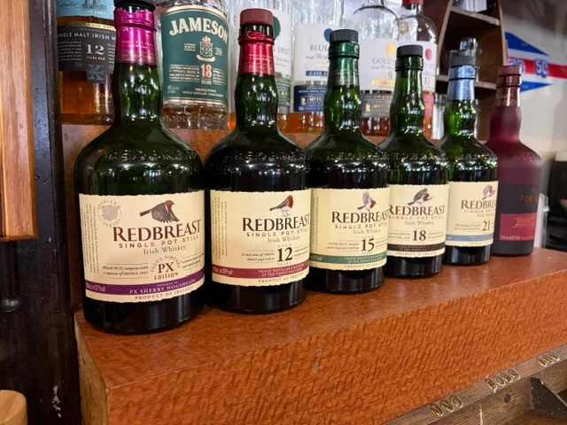 Selection of Redbreast Irish whiskey bottles on a bar shelf