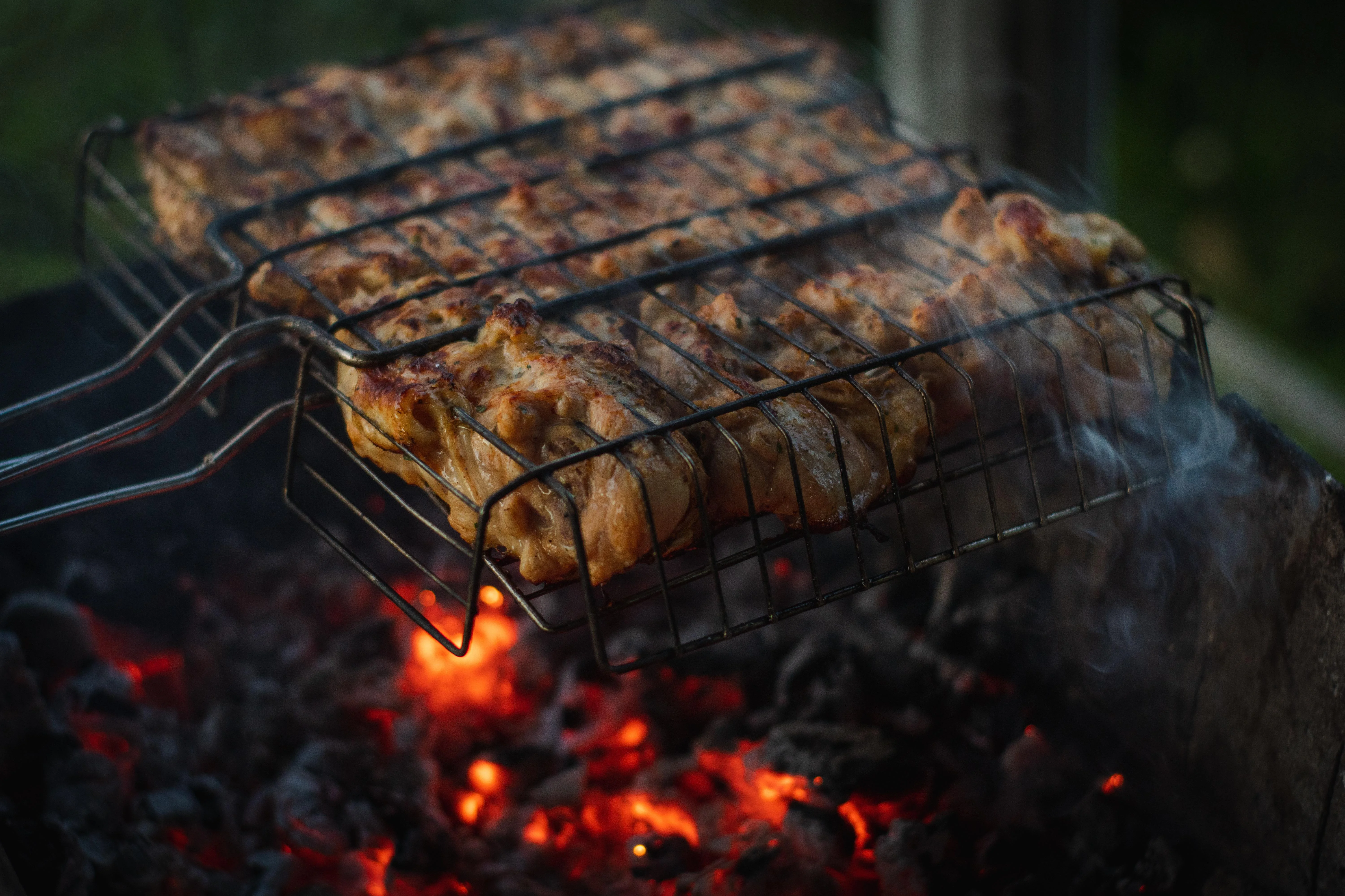 Grilled kebabs cooking over charcoal flames