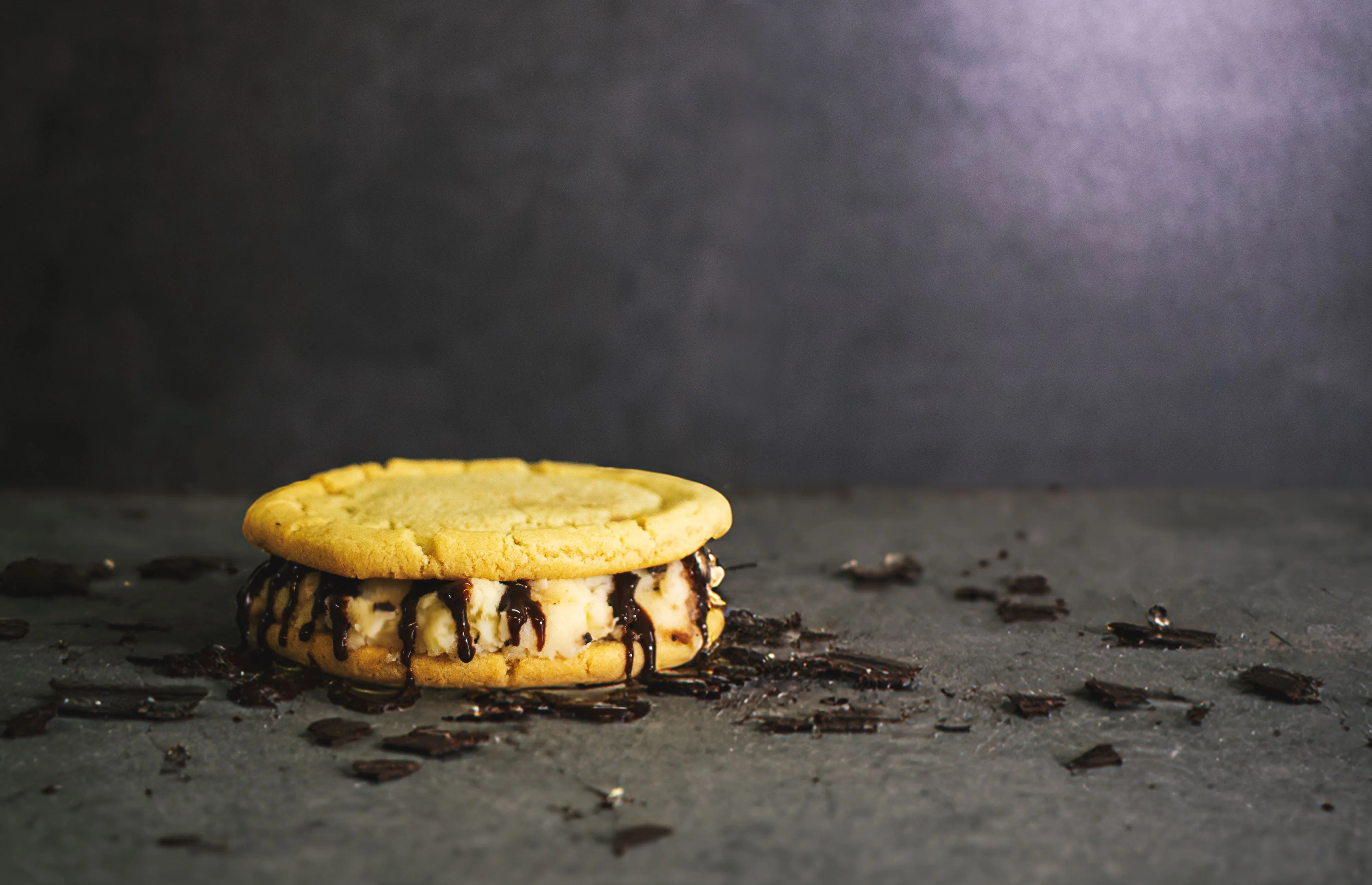 Delicious ice cream sandwich with cookie and chocolate drizzle