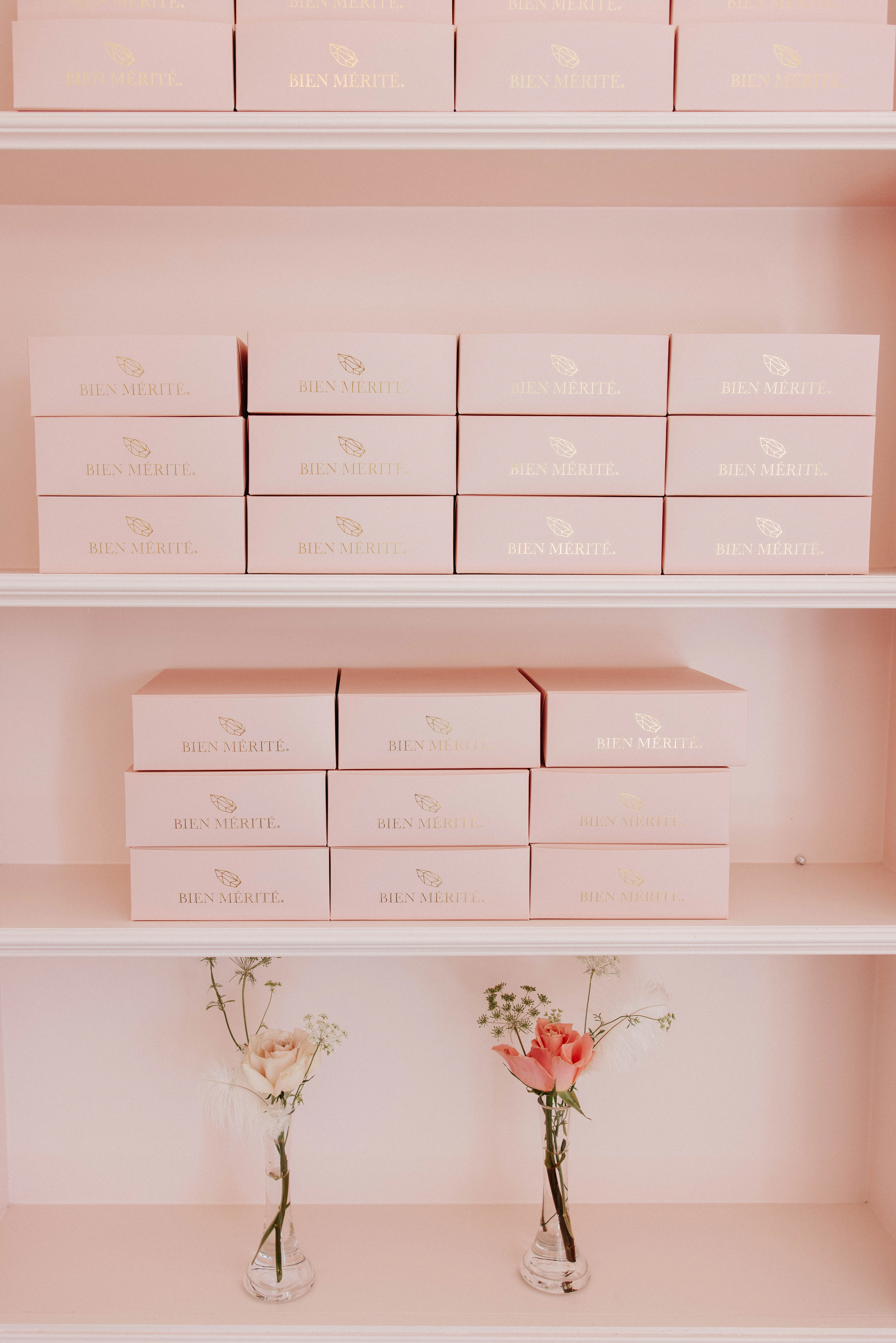 Elegant display of pink dessert boxes in a chic bakery setting