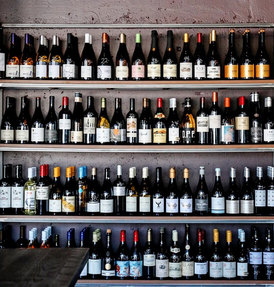 Well-stocked wine shelf with diverse bottles in a modern restaurant