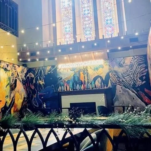 Stylish restaurant interior with stained glass and vibrant murals