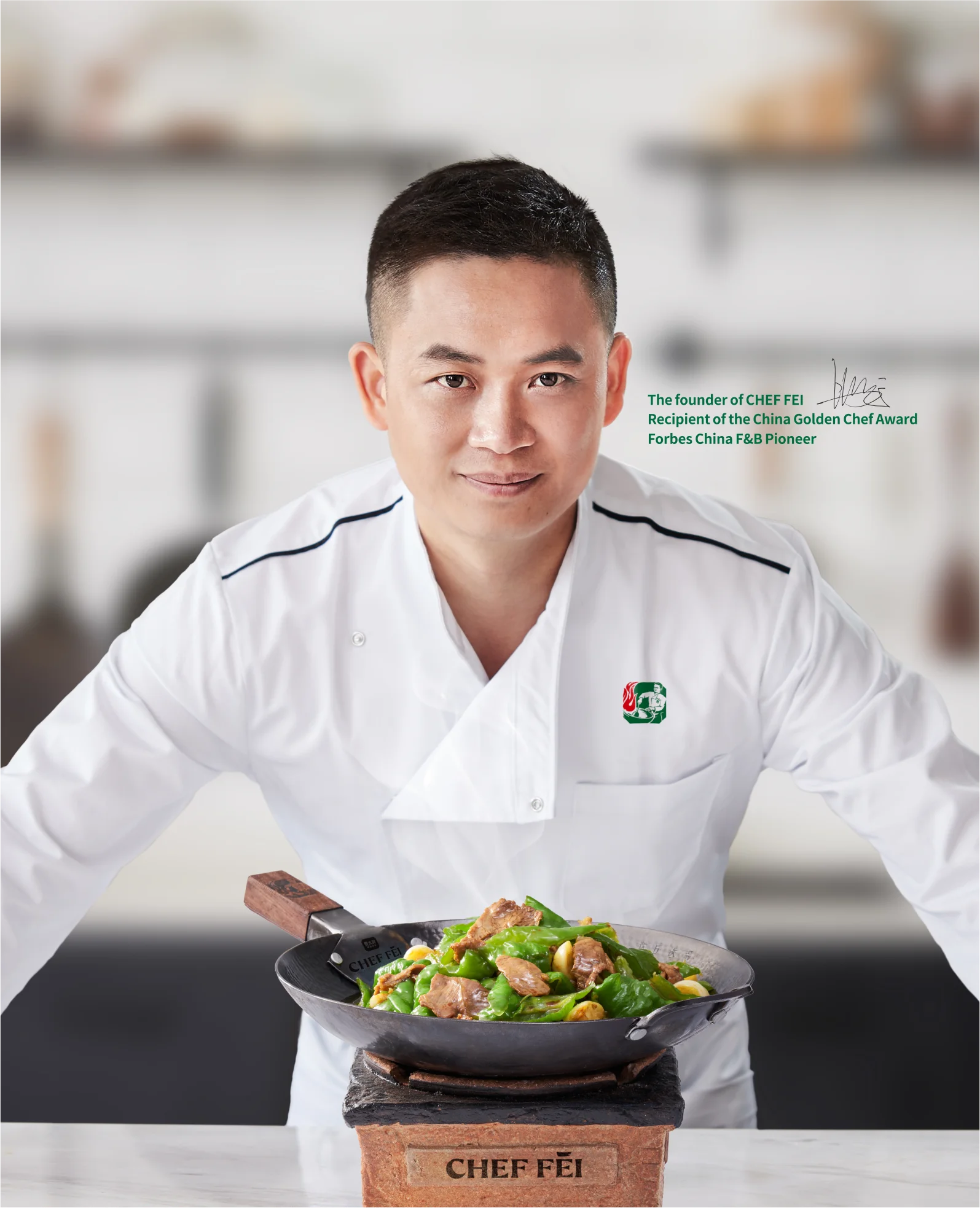 Chef in a white uniform presenting a colorful dish in a wok.