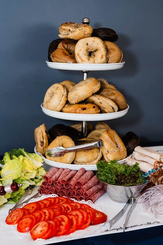 Bagel platter with assorted toppings and fresh vegetables