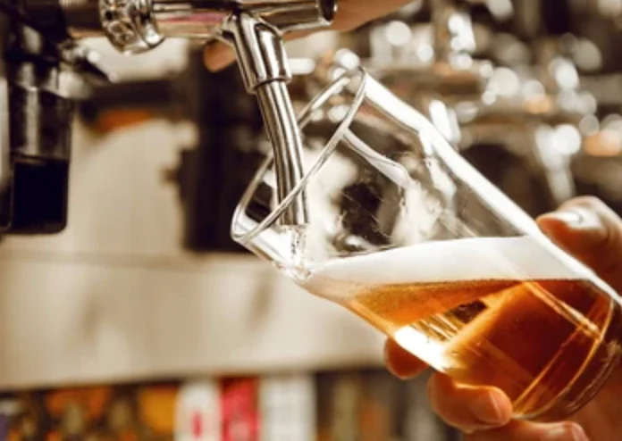 Pouring a glass of craft beer at a bar