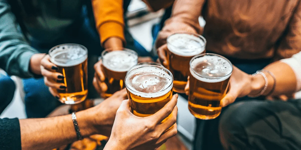 Group of friends toasting with beers in a casual setting