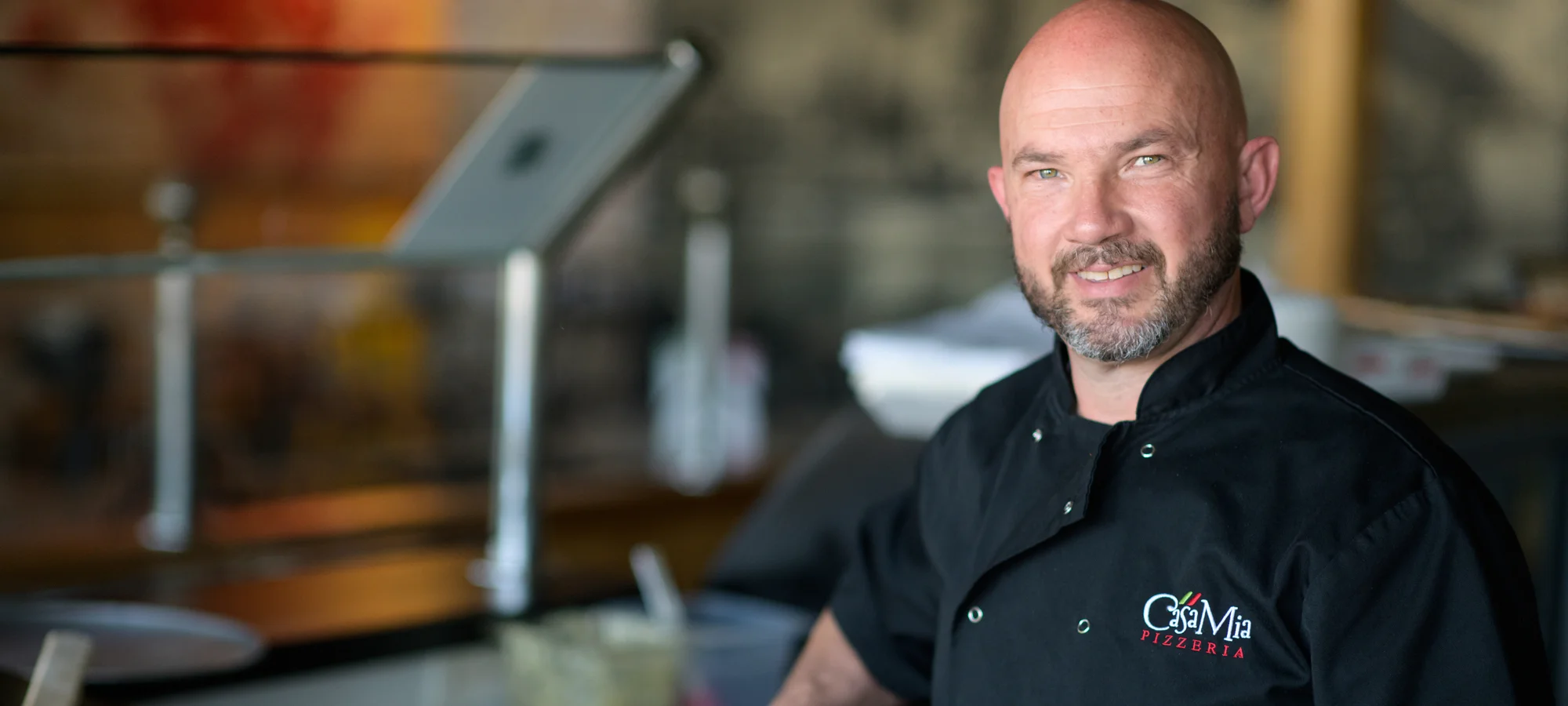 Chef presenting a freshly baked Margherita pizza