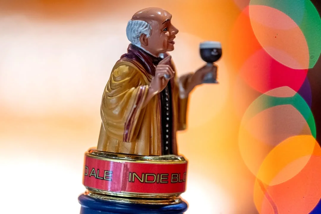 Decorative beer tap handle featuring a monk holding a glass of stout
