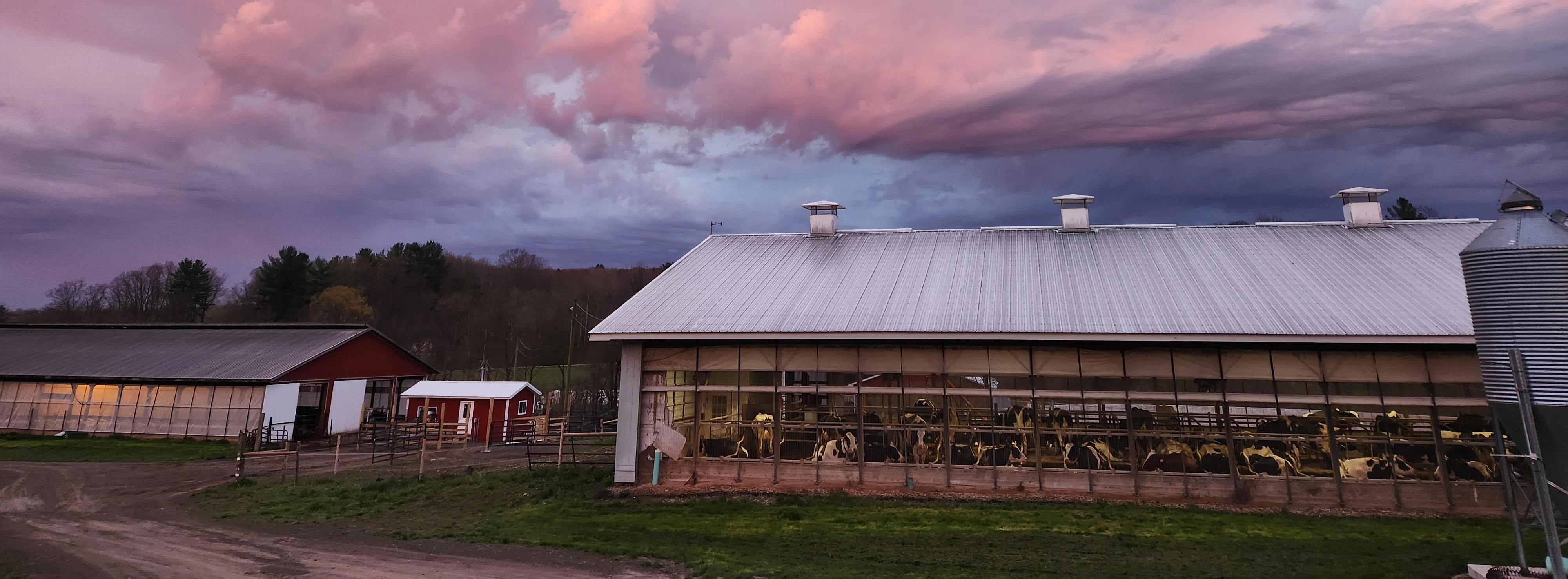 Scenic farm landscape at sunset with colorful clouds