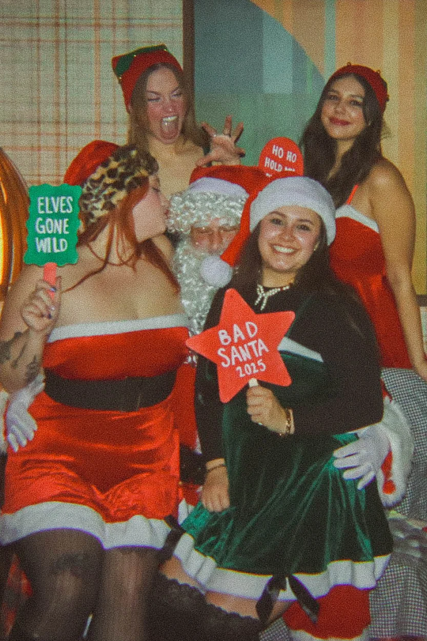 Festive holiday gathering with Santa and friends in Christmas attire