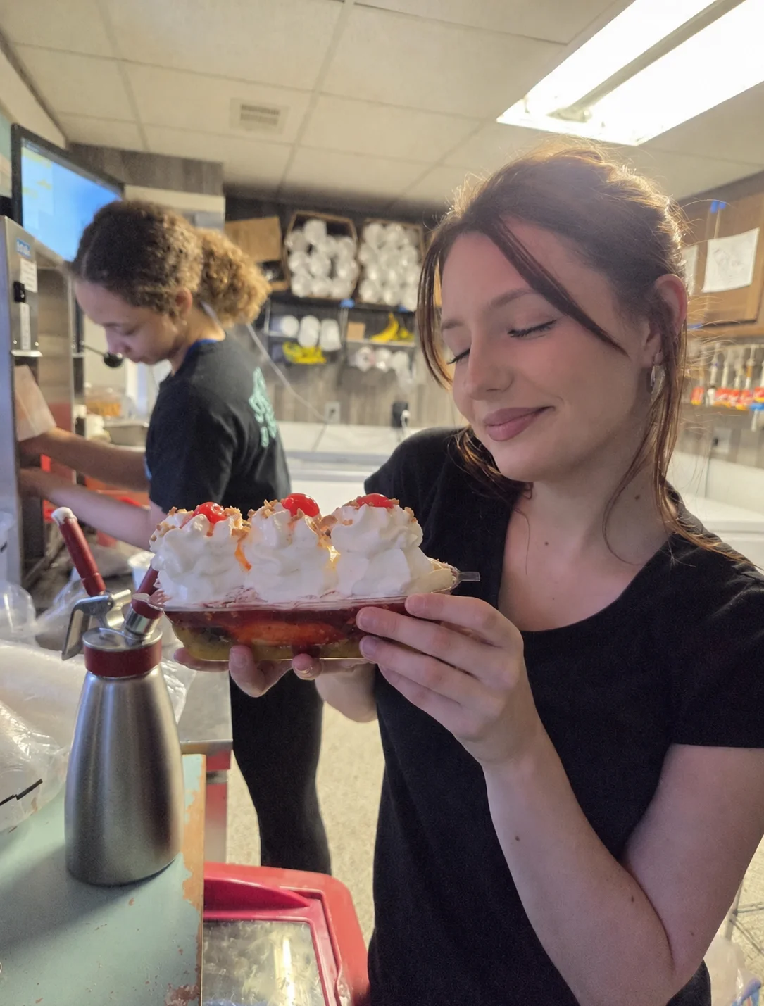Colorful ice cream sundae with whipped cream and cherries
